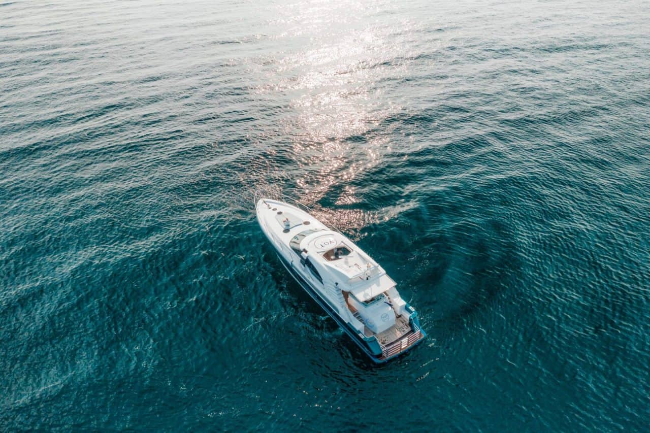 Catamaran sailing along the Hawaiian coastline at golden hour