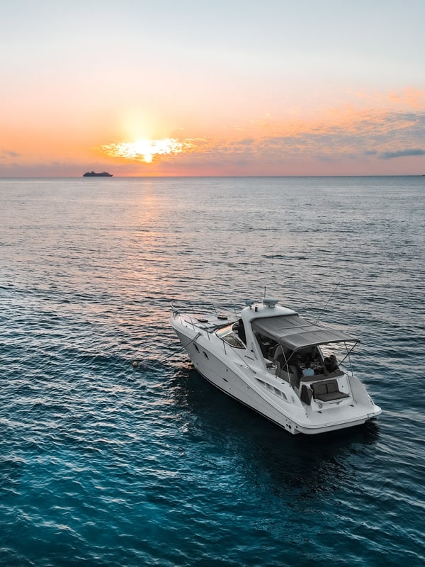 Catamaran sailing toward a Hawaiian sunset